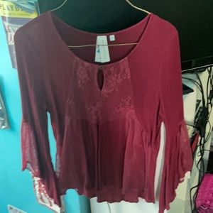 Women’s crimson blouse with lace detailed cutouts